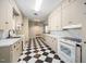 Quaint kitchen with black and white checkered floors, and ample counter space at 3074 Granville Dr, Raleigh, NC 27609