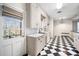Bright kitchen featuring checkered floors, and a door leading to the backyard at 3074 Granville Dr, Raleigh, NC 27609