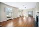 Spacious living room with hardwood floors, large windows, and a classic fireplace at 3074 Granville Dr, Raleigh, NC 27609