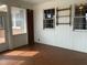 Sunroom with paneled walls, shelving and brick accent wall and tile flooring at 3074 Granville Dr, Raleigh, NC 27609