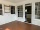 Sunroom featuring red tile flooring and multiple windows with an entry into the kitchen at 3074 Granville Dr, Raleigh, NC 27609