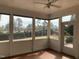 Sunroom featuring walls of windows allowing for natural light and views of the manicured lawn at 3074 Granville Dr, Raleigh, NC 27609