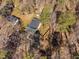 An aerial view of a single-Gathering home with a fenced yard surrounded by lush trees and greenery at 318 Holland Glen St, Fuquay Varina, NC 27526
