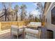 Inviting outdoor deck with comfortable seating, perfect for relaxing and enjoying the natural surroundings at 318 Holland Glen St, Fuquay Varina, NC 27526