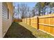Backyard with a wood fence offering privacy and space for outdoor activities at 318 Holland Glen St, Fuquay Varina, NC 27526