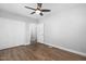 A bright bedroom with hardwood floors, ceiling fan, and closet space at 318 Holland Glen St, Fuquay Varina, NC 27526