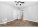 A bright bedroom with hardwood floors, ceiling fan, and closet space at 318 Holland Glen St, Fuquay Varina, NC 27526