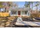 Charming home with a covered porch, tidy landscaping and a quaint walkway leading to the front door at 318 Holland Glen St, Fuquay Varina, NC 27526