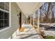 Inviting covered front porch with classic columns, stylish lighting, and a neatly maintained walkway to the entry at 318 Holland Glen St, Fuquay Varina, NC 27526