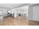 Open-concept kitchen boasts grey cabinets, stainless appliances, and center island with updated countertops and fixtures at 318 Holland Glen St, Fuquay Varina, NC 27526