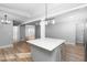 An open-concept kitchen that features an island, stainless steel appliances, and modern finishes at 318 Holland Glen St, Fuquay Varina, NC 27526