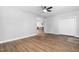 Spacious living room features new floors, fresh paint, a ceiling fan, and a view into the kitchen at 318 Holland Glen St, Fuquay Varina, NC 27526