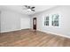 This living room features new floors, neutral paint, a modern ceiling fan, and plenty of natural light at 318 Holland Glen St, Fuquay Varina, NC 27526
