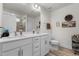 Well-lit bathroom featuring a double vanity, a framed mirror, and tile floors at 40 Glendavis Hollow Dr, Franklinton, NC 27525