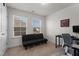Bright bedroom featuring a futon, carpet, and a desk with natural light from two windows at 40 Glendavis Hollow Dr, Franklinton, NC 27525