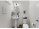 Clean half bathroom featuring a pedestal sink, decorative mirror, and modern fixtures at 40 Glendavis Hollow Dr, Franklinton, NC 27525
