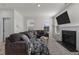 Inviting living room with a fireplace, plush sofa, and natural light from the windows at 40 Glendavis Hollow Dr, Franklinton, NC 27525