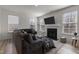 Comfortable living room featuring a large sofa, fireplace, and ample natural light at 40 Glendavis Hollow Dr, Franklinton, NC 27525