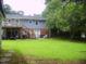 The backyard features a two-story deck, ample greenspace and shade at 4408 Leota Dr, Raleigh, NC 27603