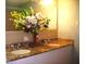 Bathroom featuring double sinks, granite countertops, and tiled accents at 4408 Leota Dr, Raleigh, NC 27603