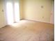 This bedroom features neutral carpet, white walls and white sliding door to the back at 4408 Leota Dr, Raleigh, NC 27603