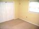This bedroom features neutral carpet, white walls and a closet that provides space at 4408 Leota Dr, Raleigh, NC 27603