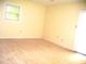 This bedroom features neutral carpet, white walls and a window that provides natural light at 4408 Leota Dr, Raleigh, NC 27603