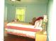 Bedroom with a window letting in natural light and a flower vase on the nightstand at 4408 Leota Dr, Raleigh, NC 27603