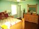Cozy bedroom with a teddy bear, flowers, and a wooden dresser at 4408 Leota Dr, Raleigh, NC 27603