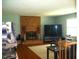 Cozy living room featuring a brick fireplace, hardwood floors, and natural light at 4408 Leota Dr, Raleigh, NC 27603