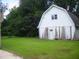 This outbuilding features a white exterior and a modest yard at 4408 Leota Dr, Raleigh, NC 27603