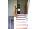 Inviting foyer features a staircase with a wooden railing and an open door at 4408 Leota Dr, Raleigh, NC 27603