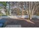 Tranquil backyard with mature trees and a well-maintained fence offers privacy and shade at 4828 Morning Edge Dr, Raleigh, NC 27613
