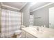 Well-lit bathroom featuring a large mirror, vanity with sink, toilet, and shower with curtain at 4828 Morning Edge Dr, Raleigh, NC 27613
