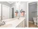 Bright bathroom featuring double sinks, a large mirror, and plenty of natural light at 4828 Morning Edge Dr, Raleigh, NC 27613