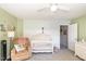 Nicely decorated Bedroom featuring a crib, dresser, recliner, and character themed decor at 4828 Morning Edge Dr, Raleigh, NC 27613