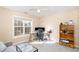 Cozy bedroom featuring a work area by the bright window and a display shelf for decor at 4828 Morning Edge Dr, Raleigh, NC 27613