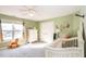 Cute Bedroom with soft green walls, a white crib, and Winnie-the-Pooh themed decorations at 4828 Morning Edge Dr, Raleigh, NC 27613