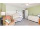 Well-decorated Bedroom with a white crib, dresser, recliner, and decorative wallpaper at 4828 Morning Edge Dr, Raleigh, NC 27613