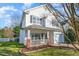 Charming two-story home with a front porch, a well-manicured lawn, and an attached garage at 4828 Morning Edge Dr, Raleigh, NC 27613