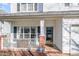 Cozy front porch with white railings and brick accents, offering a welcoming entrance at 4828 Morning Edge Dr, Raleigh, NC 27613
