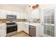 Well-equipped kitchen with white cabinets, stainless steel appliances, and mosaic backsplash at 4828 Morning Edge Dr, Raleigh, NC 27613