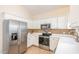 Well-lit kitchen with stainless steel appliances, white cabinets, and decorative backsplash at 4828 Morning Edge Dr, Raleigh, NC 27613