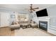 Comfortable living room featuring a fireplace, a large window, and a plush sectional sofa at 4828 Morning Edge Dr, Raleigh, NC 27613