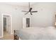 A secondary view of the spacious bedroom featuring a bed, ceiling fan, and open doorway at 4828 Morning Edge Dr, Raleigh, NC 27613