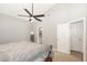 Another view of the spacious bedroom featuring a bed, ceiling fan, doorway, and adjacent bathroom at 4828 Morning Edge Dr, Raleigh, NC 27613