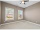 Bedroom featuring two windows and neutral-toned walls with bright white trim at 504 Crooked Pine Dr, Cary, NC 27519