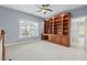 Spacious bedroom featuring custom built-in shelves, a ceiling fan, and a large window at 504 Crooked Pine Dr, Cary, NC 27519