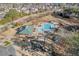 Aerial view of the community pool and playground nestled among mature trees at 504 Crooked Pine Dr, Cary, NC 27519