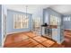 Bright dining room featuring sliding glass doors, hardwood flooring, and a stainless steel beverage cooler at 504 Crooked Pine Dr, Cary, NC 27519